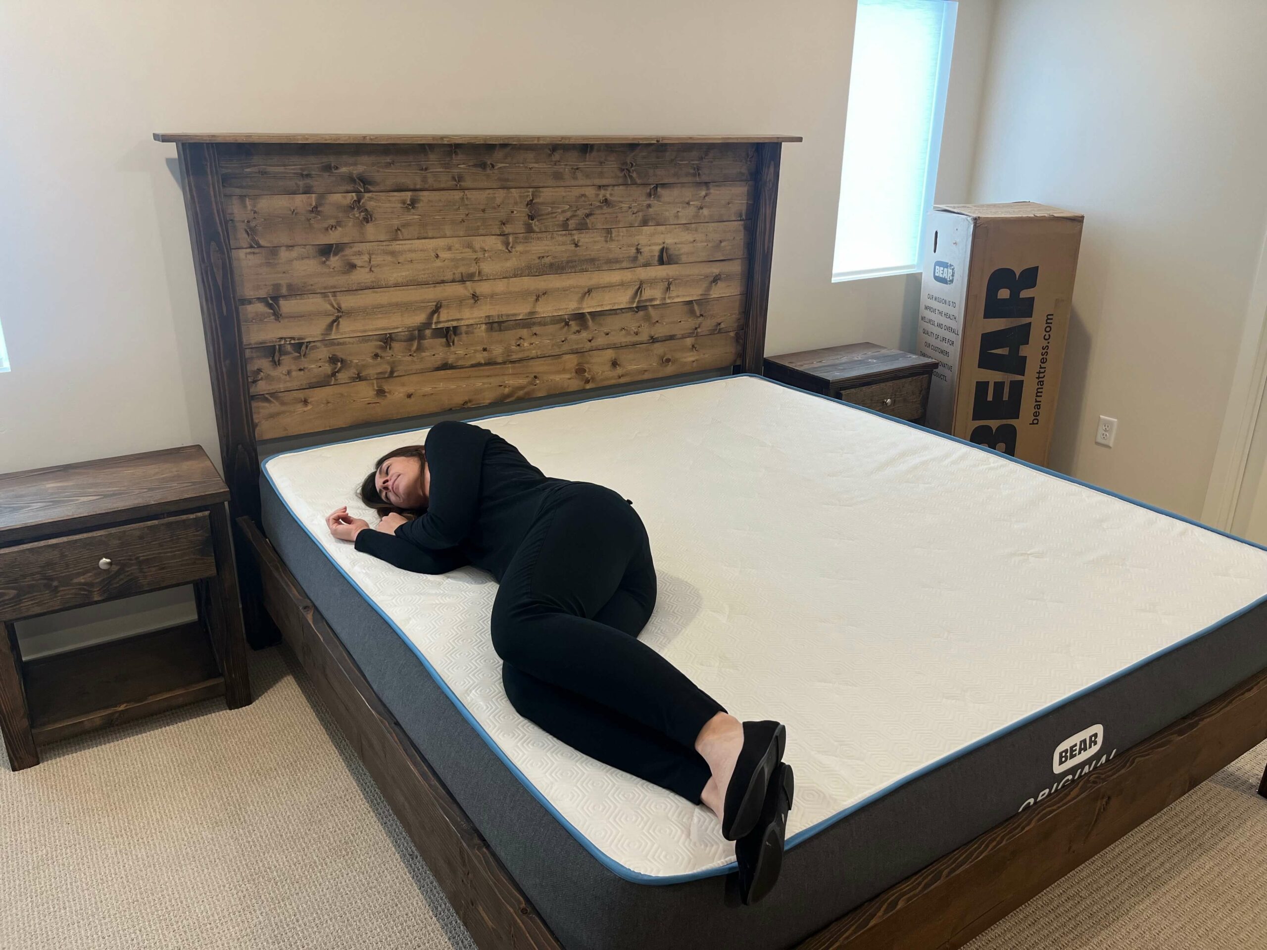 Kristina Hindes side sleeping on the Bear Original mattress to test pressure relief.