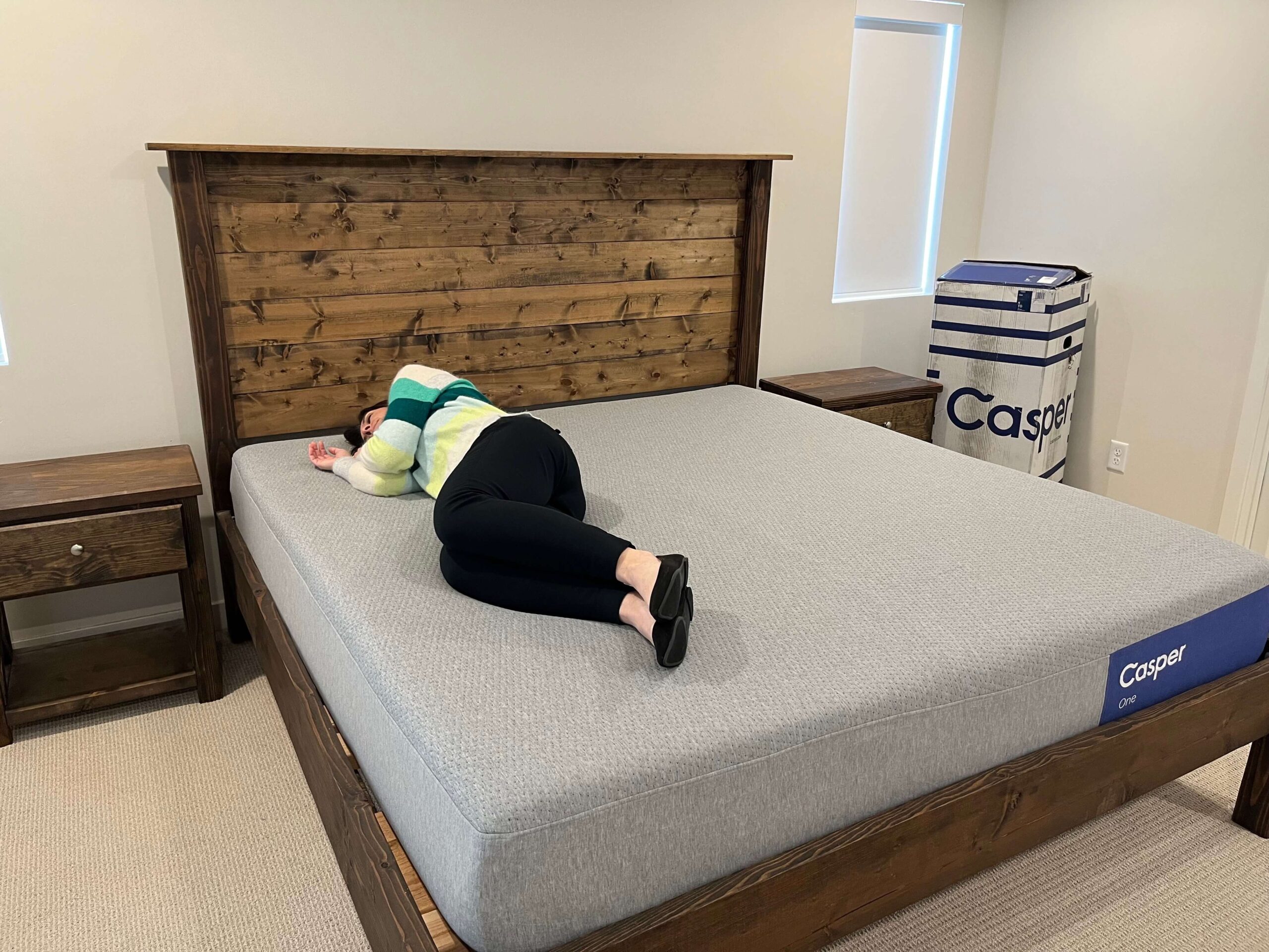 Kristina Hindes lying on her side on the Casper One mattress, demonstrating the side sleeping position.